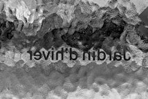 An abstract pattern with textured surface, combining shades of black, gray, and white, along with inverted text.