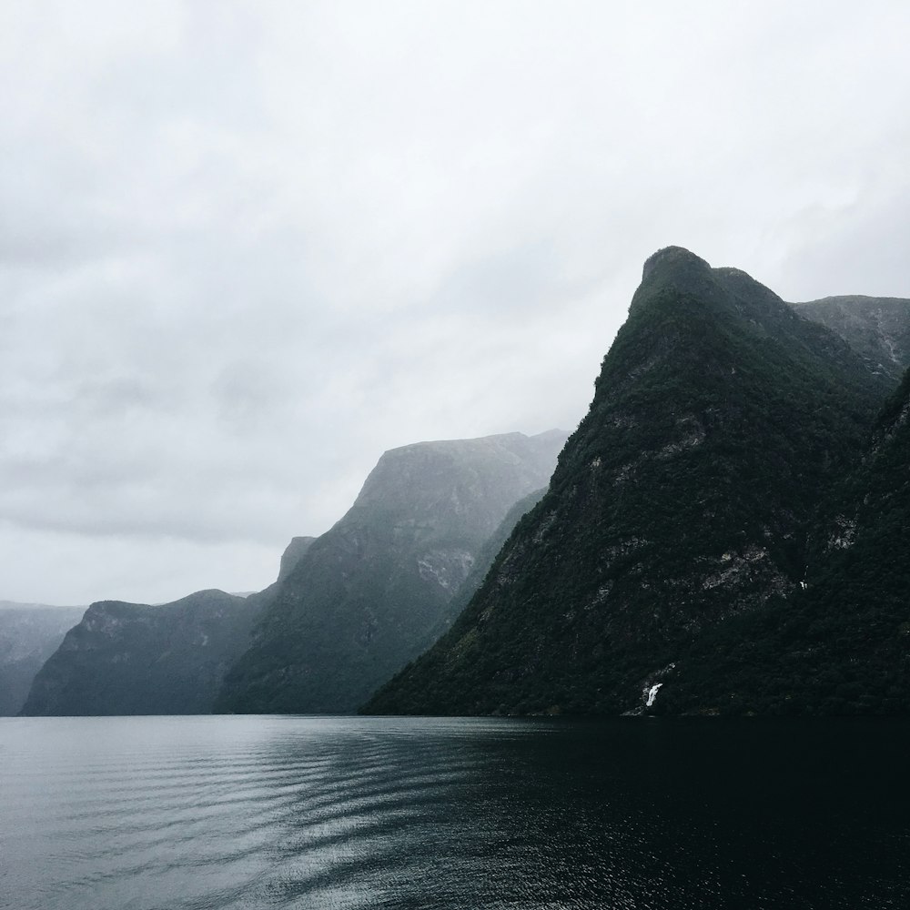 a body of water with mountains in the background