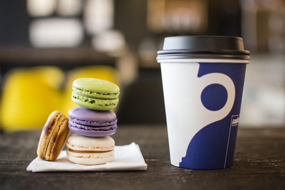 macaroons on tissue beside coffee cup
