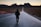 person walking in the center of the road