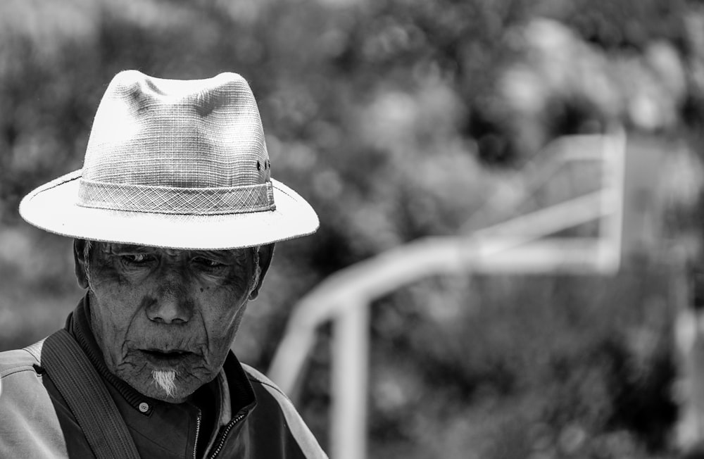 grayscale photo of man wearing hat