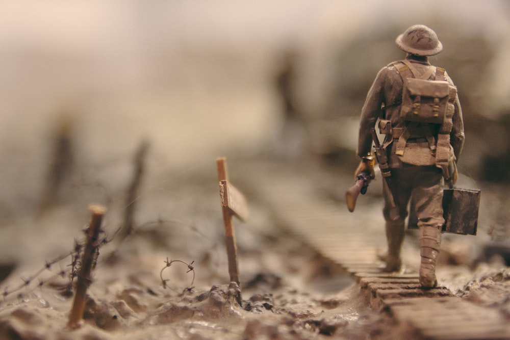 soldier walking on wooden pathway 