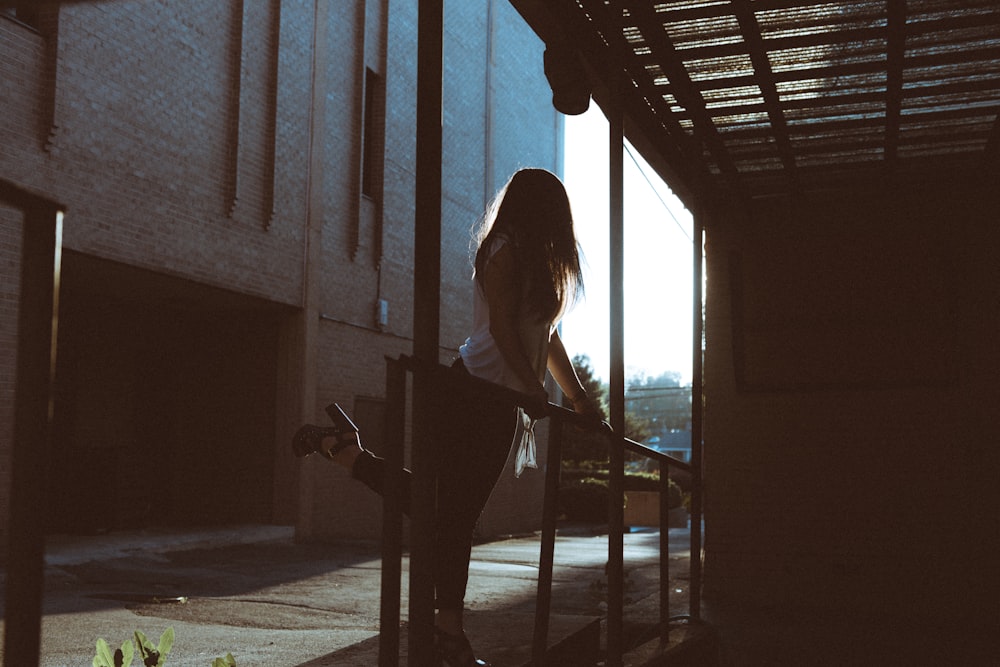 woman standing in front of metal rail