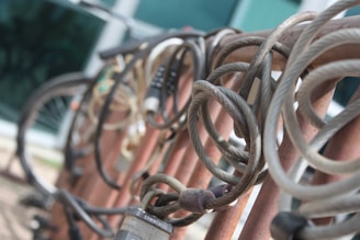 A variety of bicycle locks displayed on a wooden table.