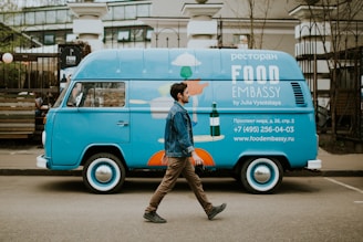 man walking beside van near concrete house