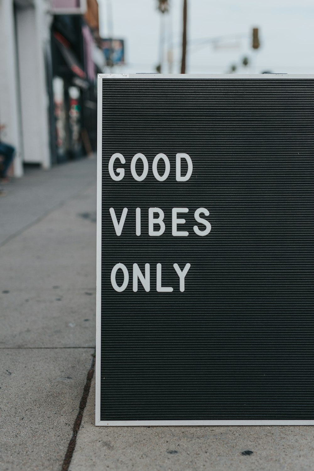 Sidewalk sign displaying "Good Vibes Only" on Sunset Strip
