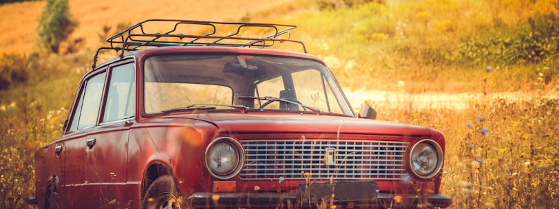 classic red car on grass field