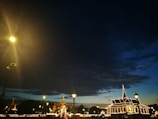 A cityscape at dusk with illuminated buildings connected by digital networks.