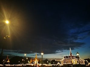 An evening cityscape with government buildings illuminated against a dark bluish-purple sky.