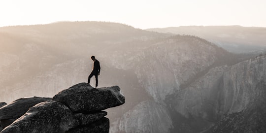 man standing on top of mountain during daytime in Glacier Point United States