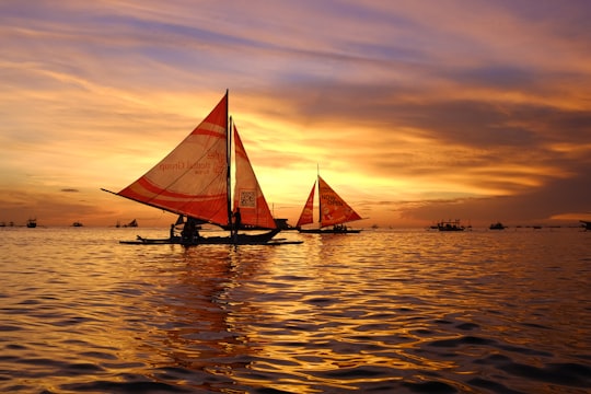 silhouette of sail boats floating on body of water in Boracay Philippines