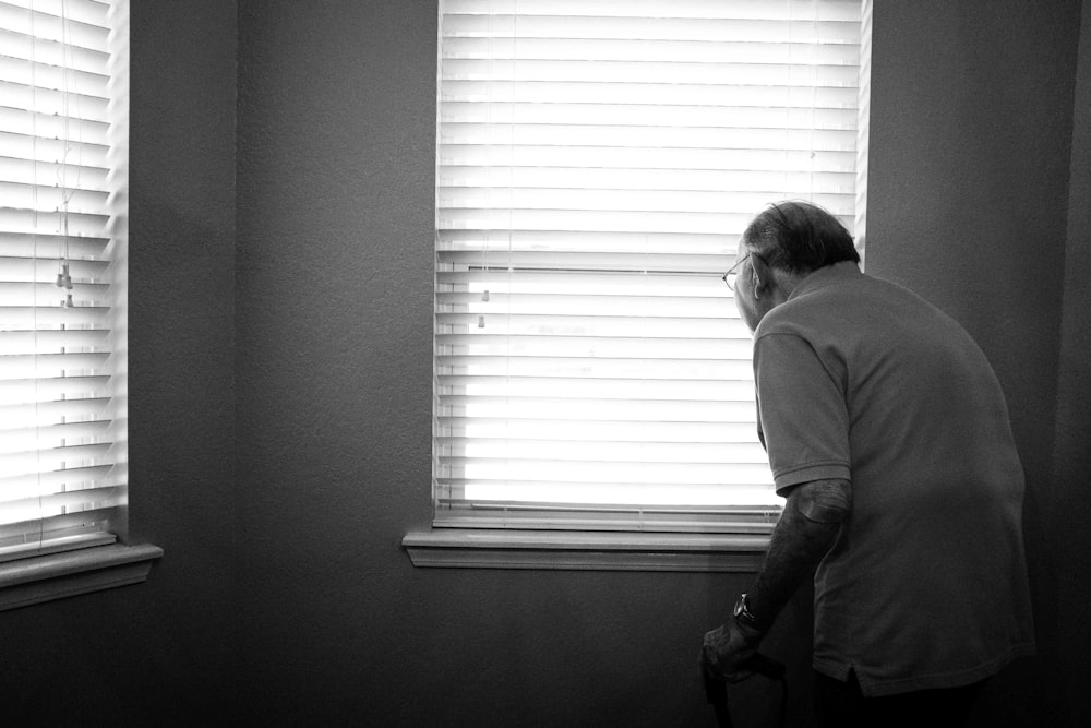 man standing inside white painted room