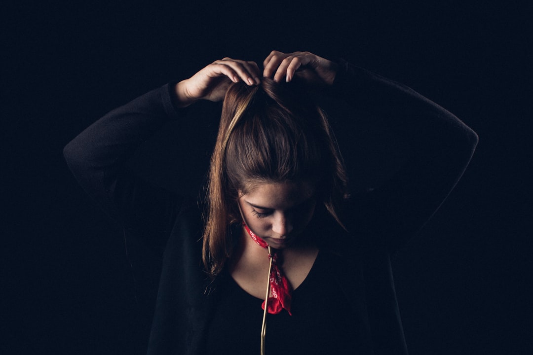 woman tying hair with both hands