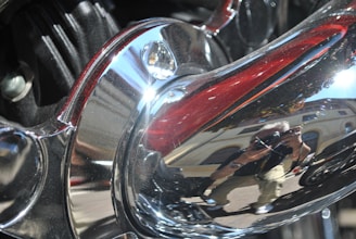 Close-up of a shiny chrome plated metal surface reflecting light.