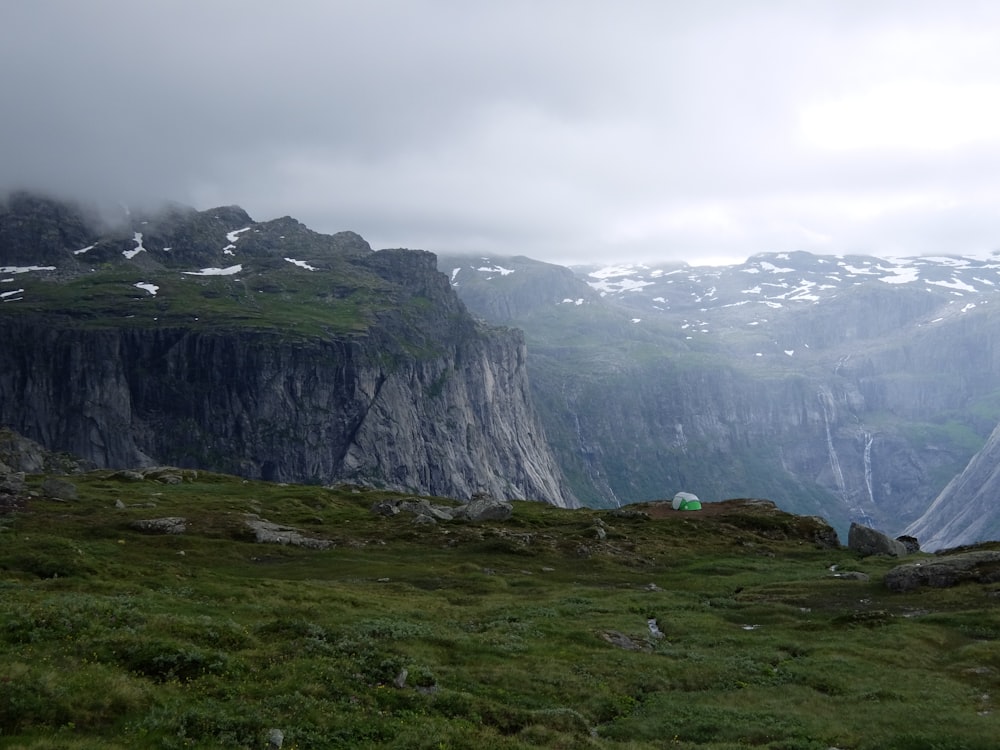 mountain range with grass and snow