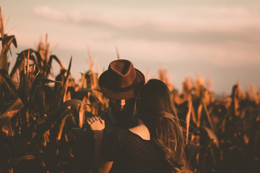 man and woman hugging each other in the field