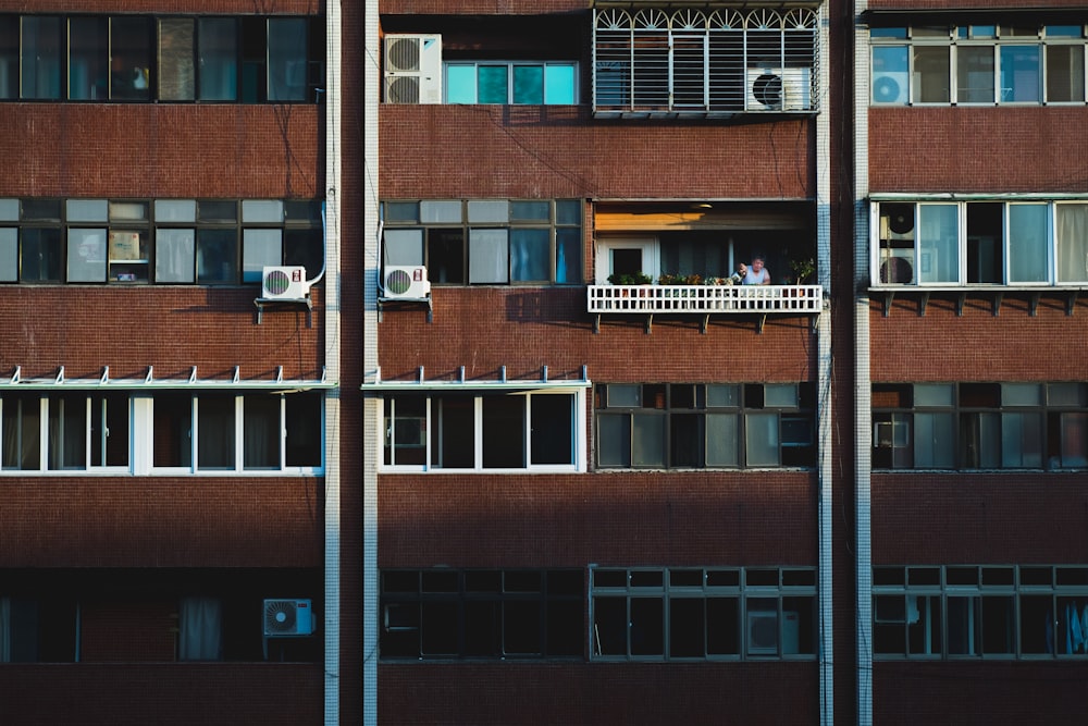person at the balcony of a building during day