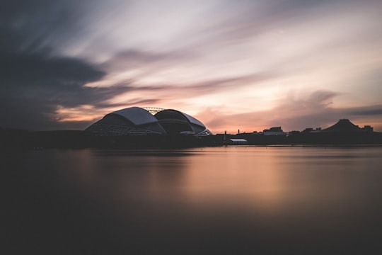 concrete building near body of water in National Stadium Singapore