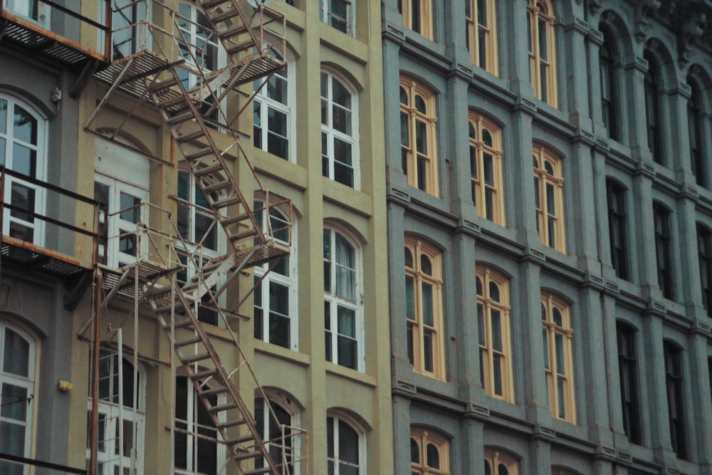 a tall building with a fire escape next to it