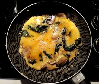 A happy cook flipping an omelette effortlessly using a stick & fin pan