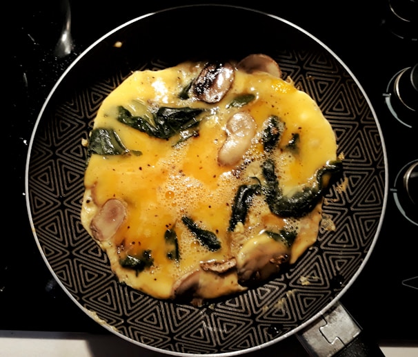 A happy cook flipping an omelette effortlessly using a stick & fin pan