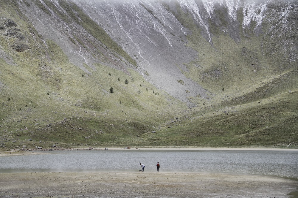 person standing beside river