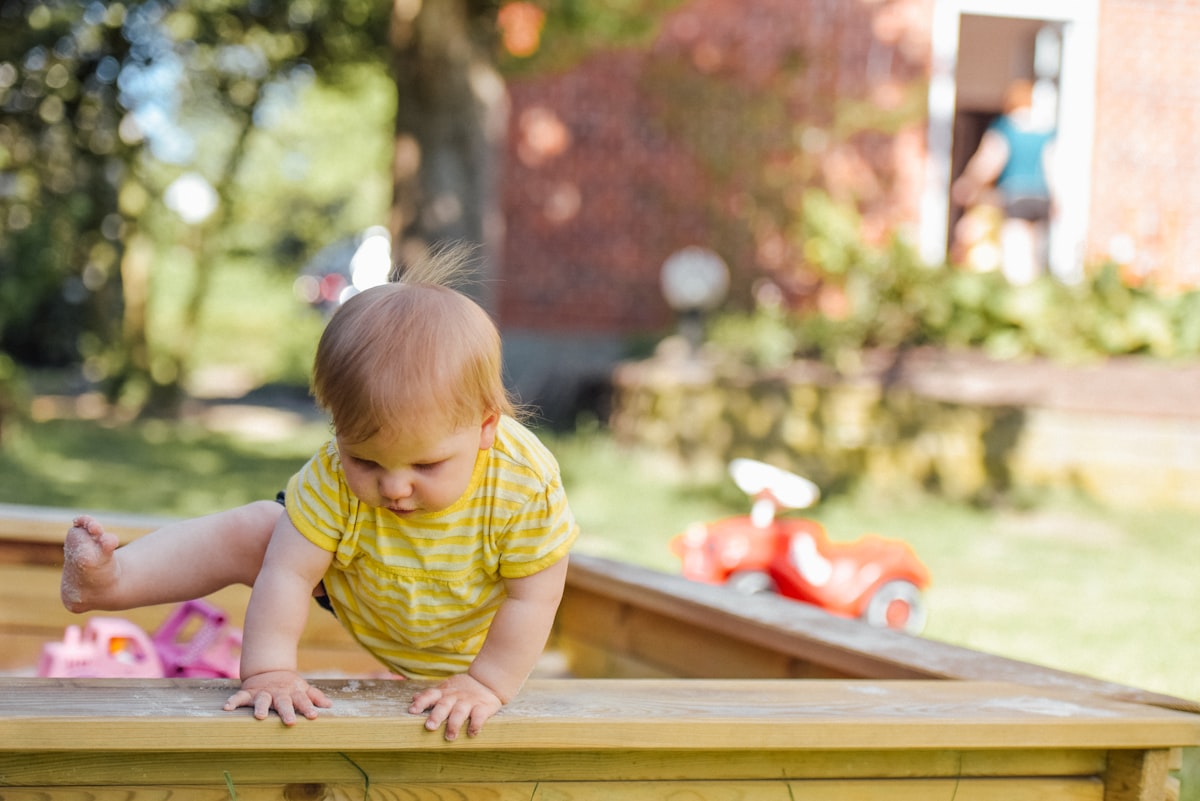 Child playing outdoors near the kitchen