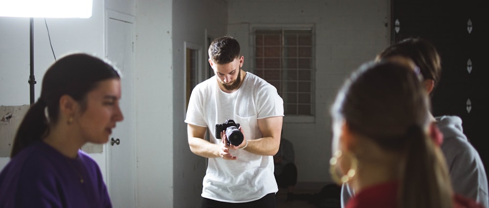 person taking photo of people during daytime