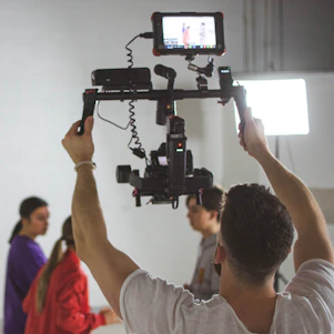 A vibrant behind-the-scenes shot of a video shoot with camera and drone in action, capturing dynamic social media content.