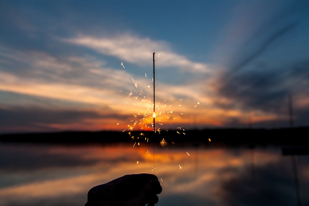 silhouette of person holding sparker