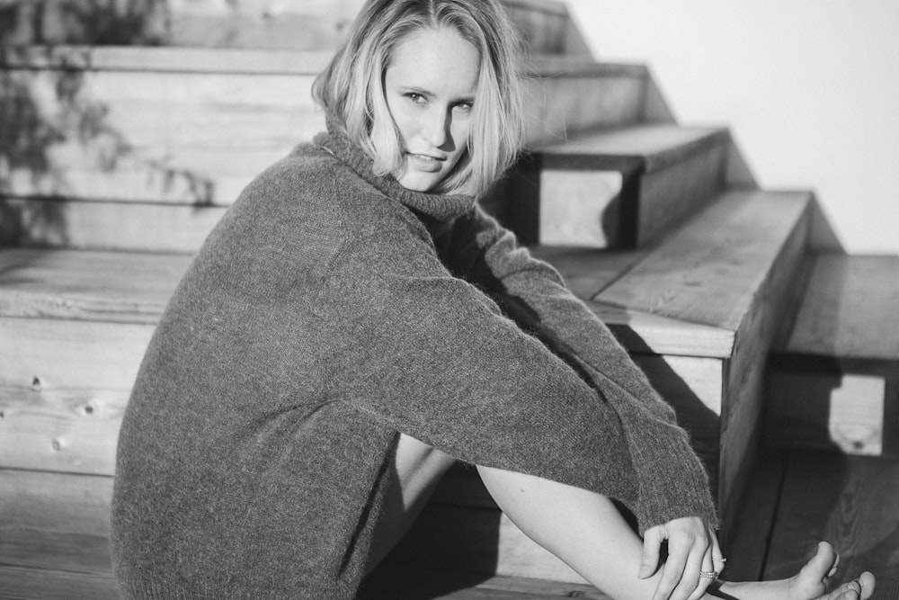 woman wearing cardigan sitting on stairs