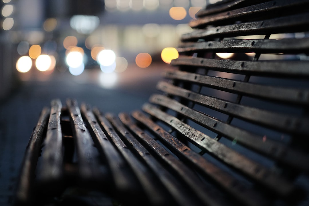 macro photography of brown wooden bench