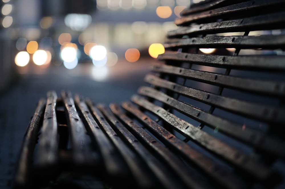 macro photography of brown wooden bench