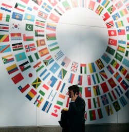 woman in black coat standing near round white red and blue wall