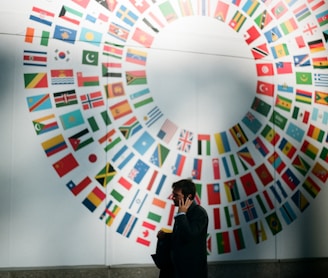 woman in black coat standing near round white red and blue wall