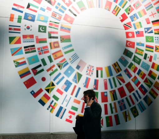 woman in black coat standing near round white red and blue wall