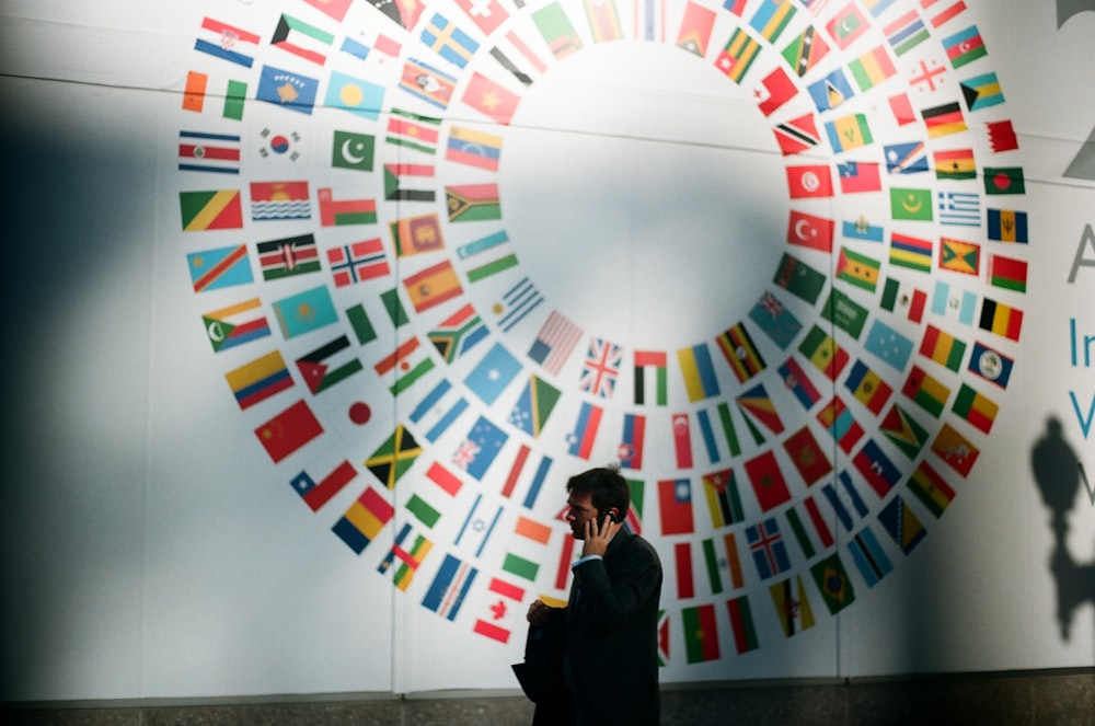 woman in black coat standing near round white red and blue wall