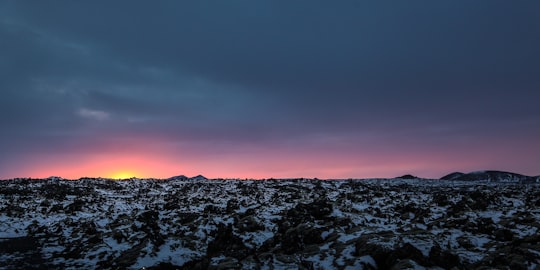 snow covered field with sunrise in Blue Lagoon Iceland