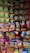 A display rack filled with various flavored snack packets, mainly chips from brands like Lay's and Kurkure, arranged in a colorful and visually appealing manner.