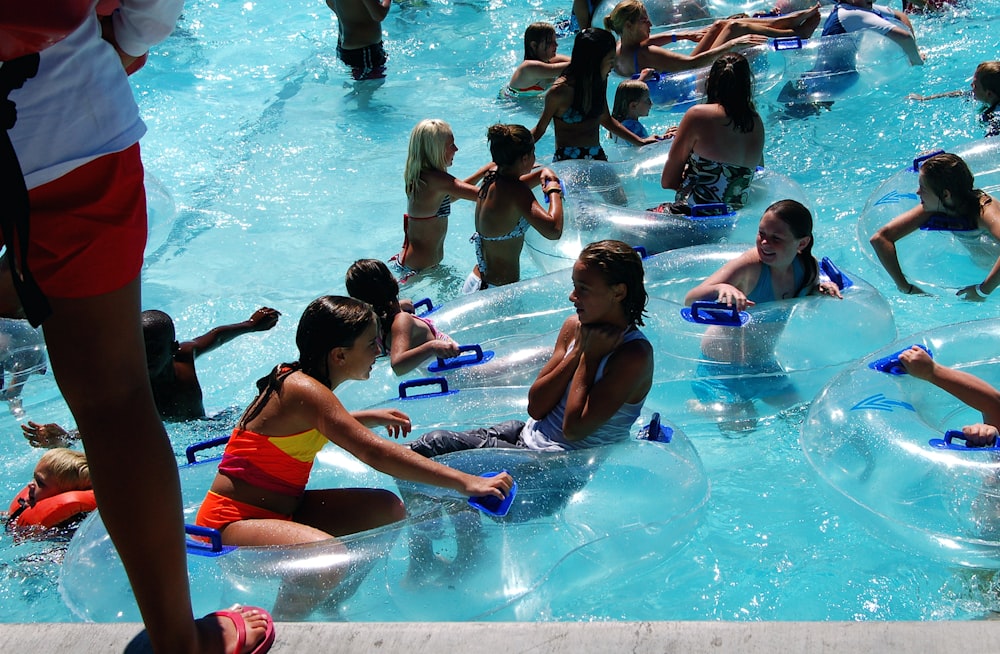 people in swimming pool during daytime