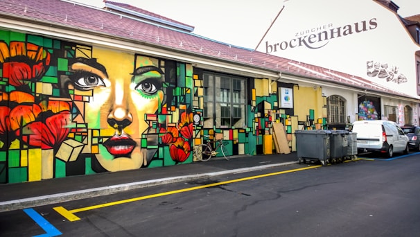 A vibrant street mural in Bern depicting diverse cultural expressions.