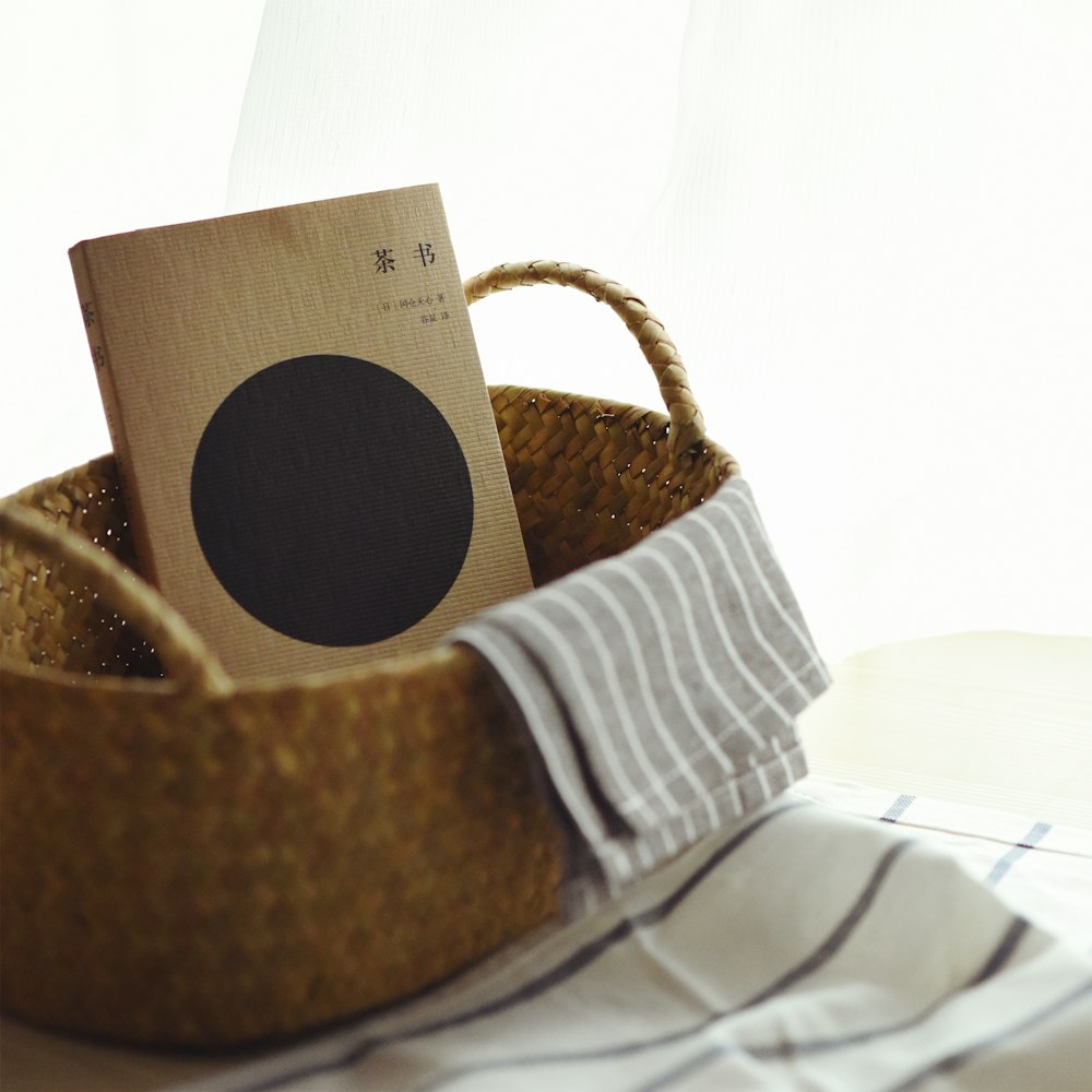 book inside brown wicker basket