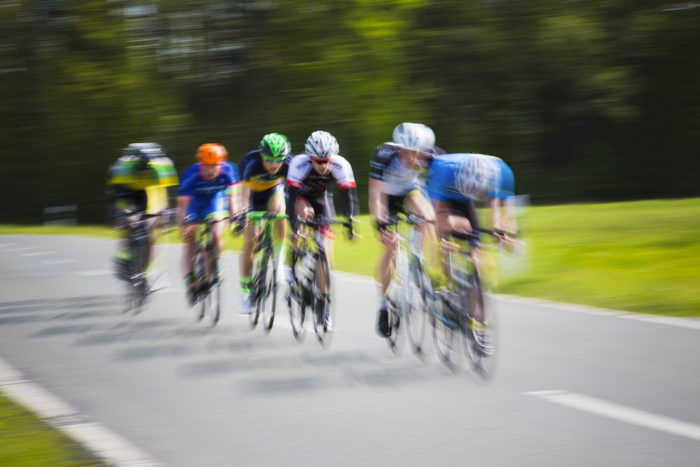 selective focus photography of cyclists on road during daytime