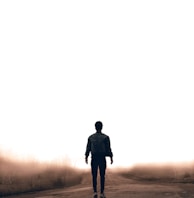 man walking along road