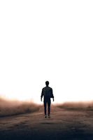 man walking along road