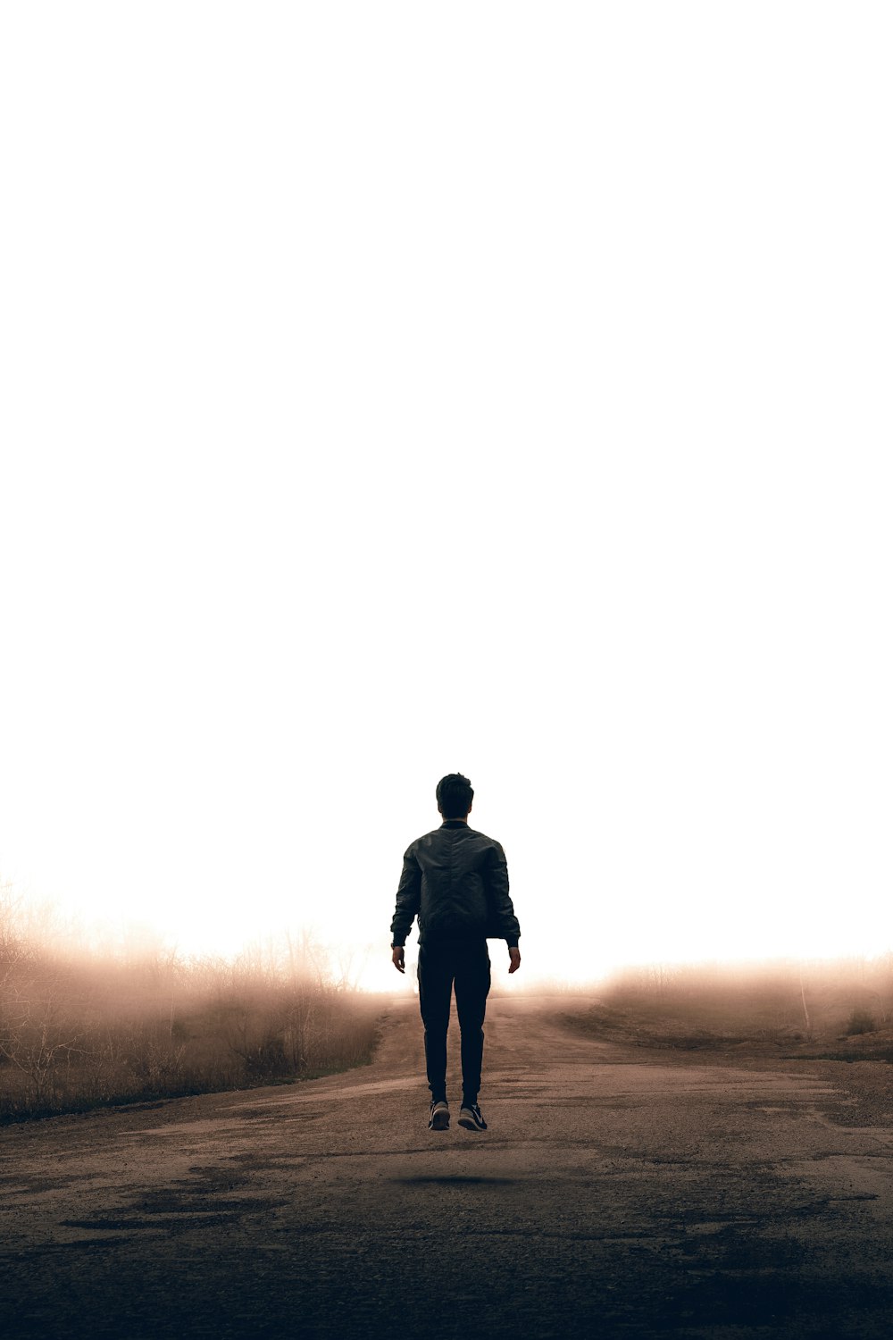 man walking along road