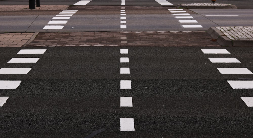 black and gray concrete road with white lanes