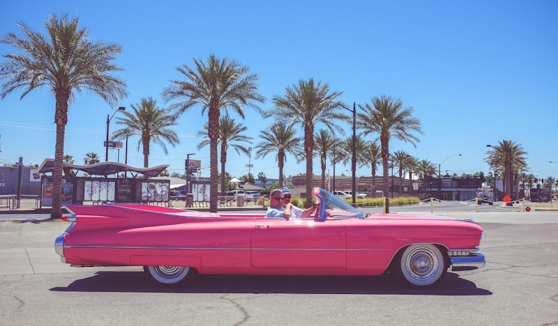 Pink convertible car with palm trees in Florida