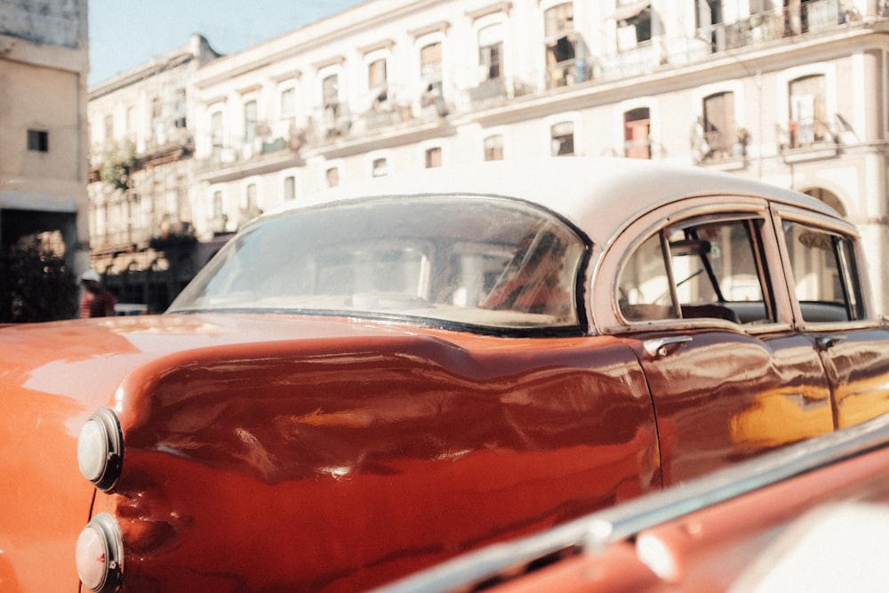 close up photography of red and white sedan