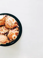 A colorful assortment of pastries arranged on a rustic ceramic plate.